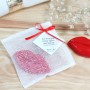 Le savon bisou dans sa pochette en tarlatane